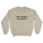 a beige sweatshirt with "Not mom's favorite" written across the chest