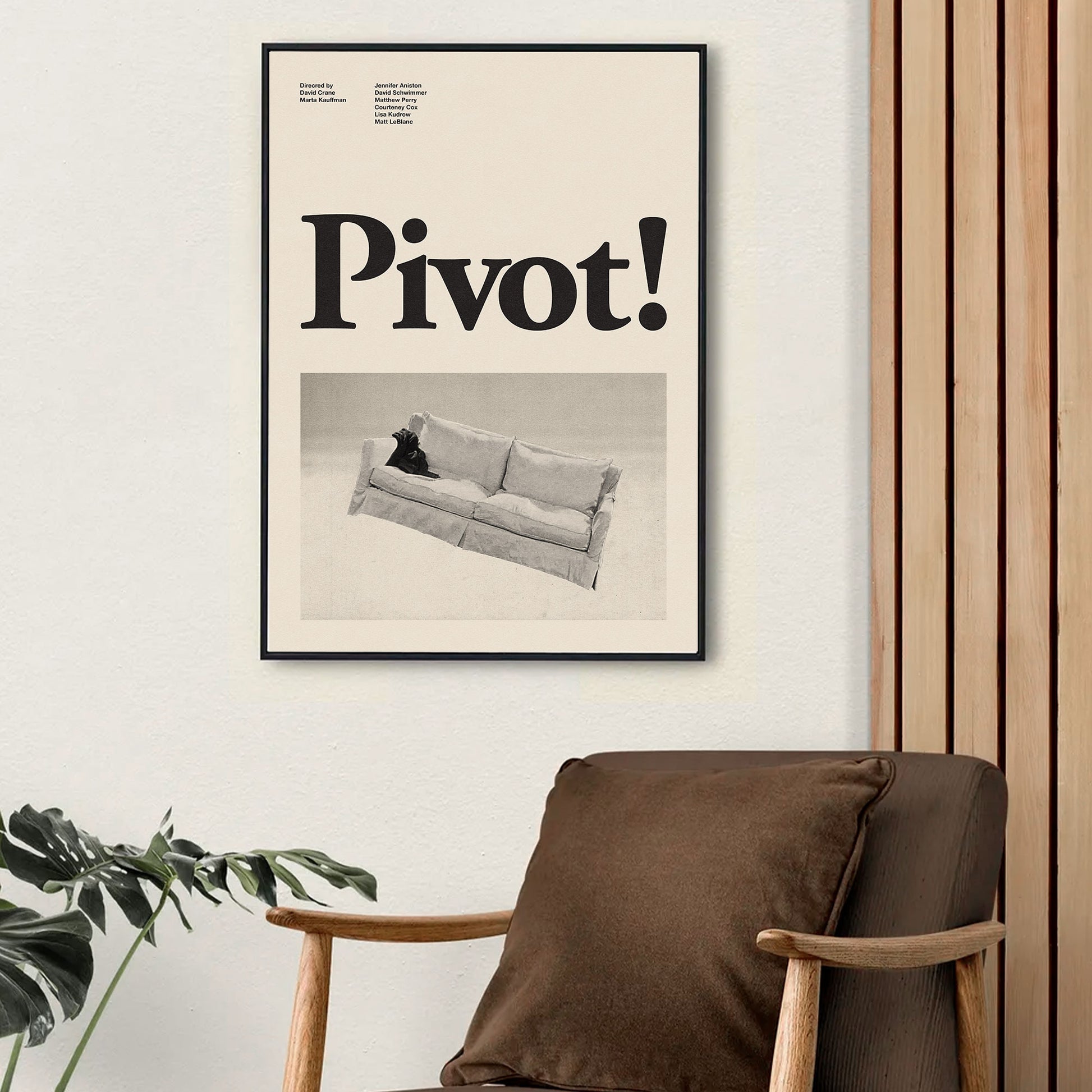 A minimalist mid century modern art print featuring the word "pivot" from the television series friends in black and white hanging on the wall